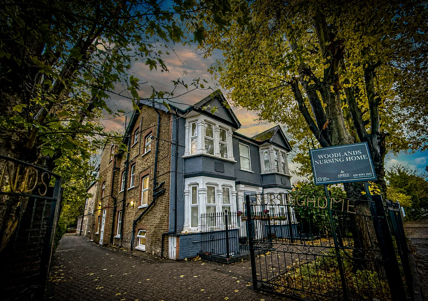 Woodlands Total Care Nursing Home under a warm sky